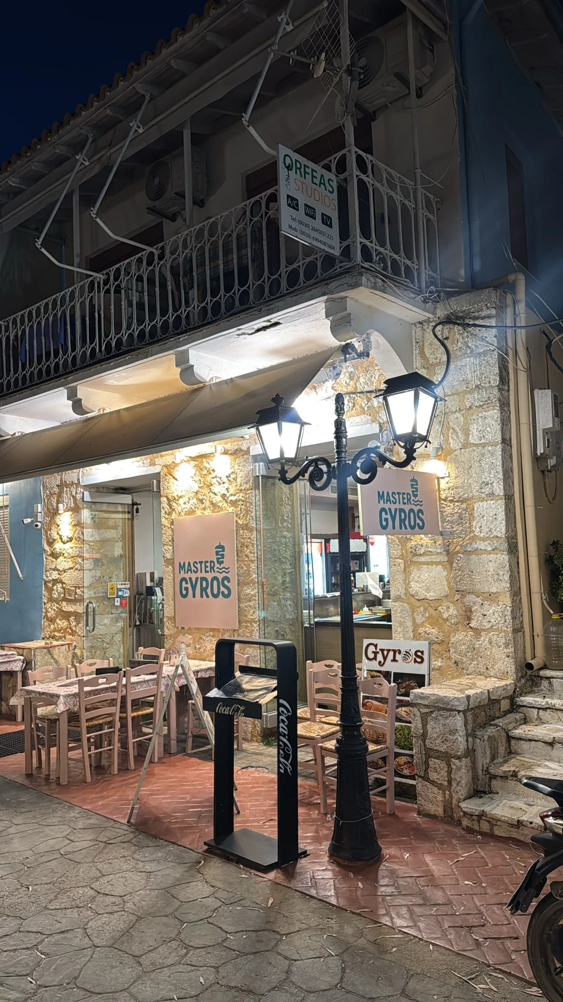 Master Gyros storefront in Vasiliki at night
